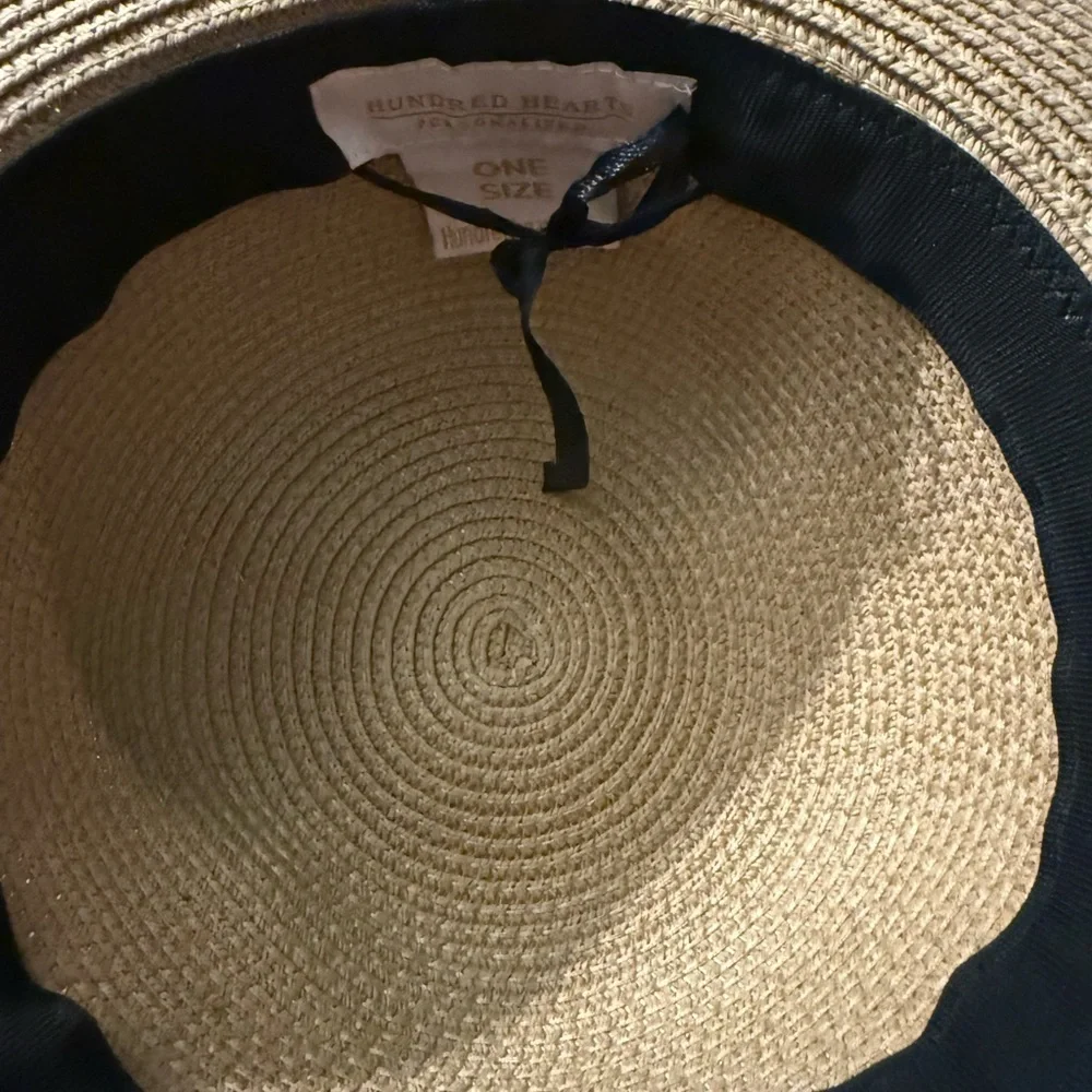 Hundred hearts straw oversized sun hat with black poms around the crown